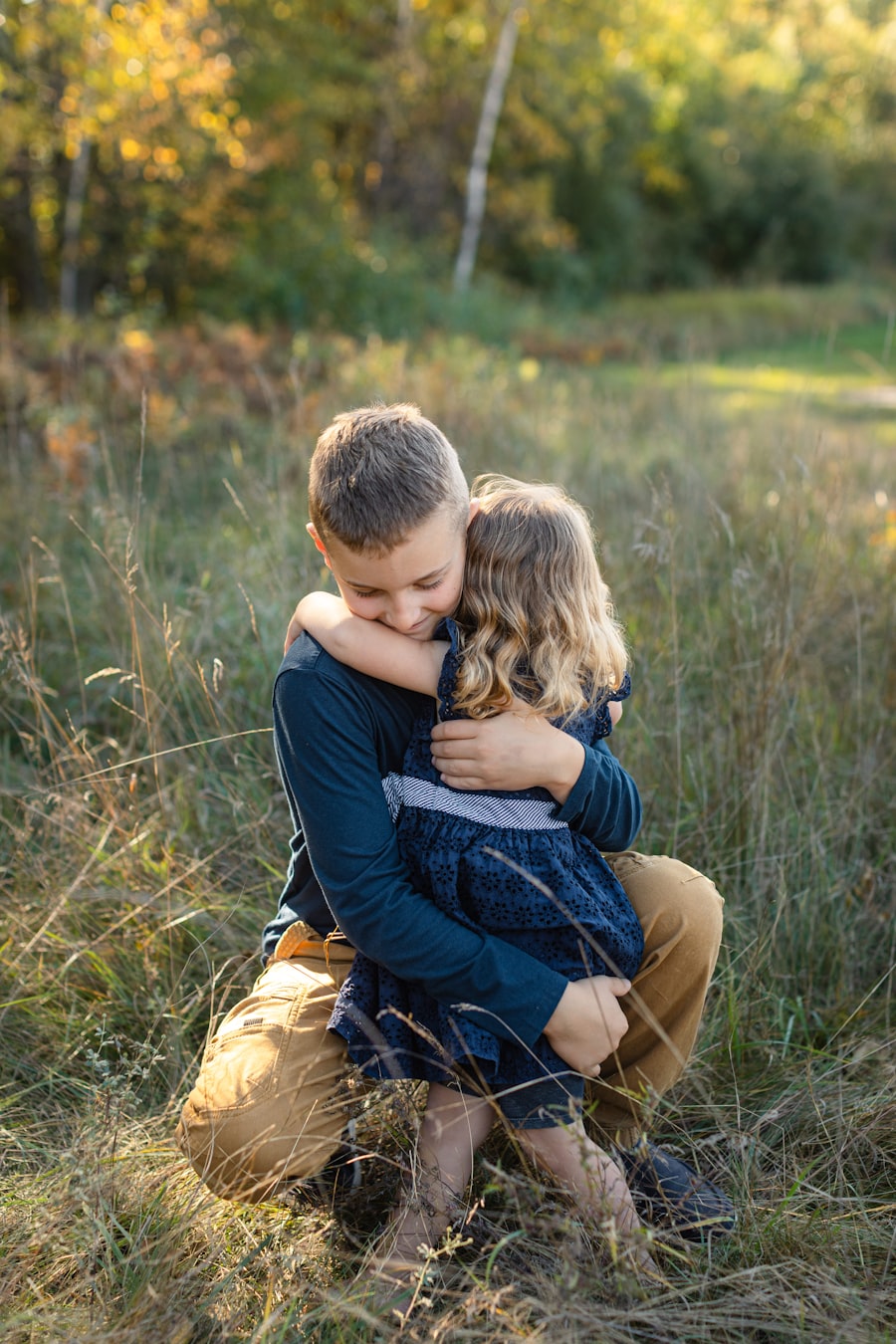 A brother and sister together in a golden meadow